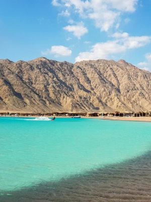 Kite surfing in Dahab , with mountains in background and clear beach water in sunny day , Blue lagoon , abo ghaloom , three pools