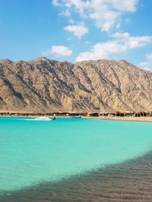 Kite surfing in Dahab , with mountains in background and clear beach water in sunny day , Blue lagoon , abo ghaloom , three pools